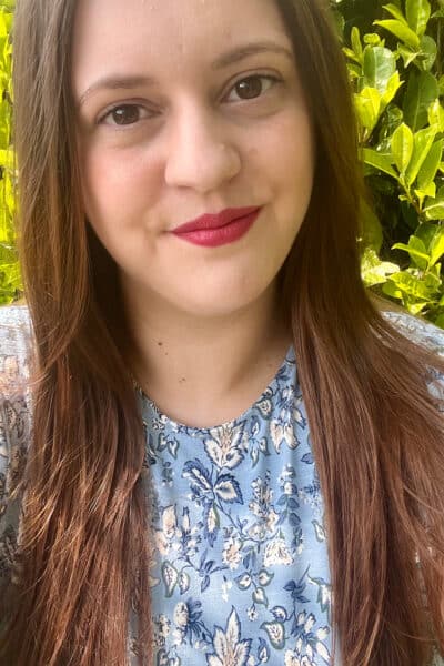 Picture is of myself. A white woman, with long brown hair, brown eyes and wearing a blue floral pattern dress.